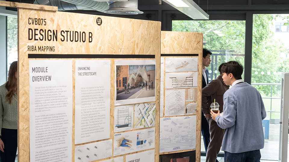 A group of displays on a wall with people looking at them